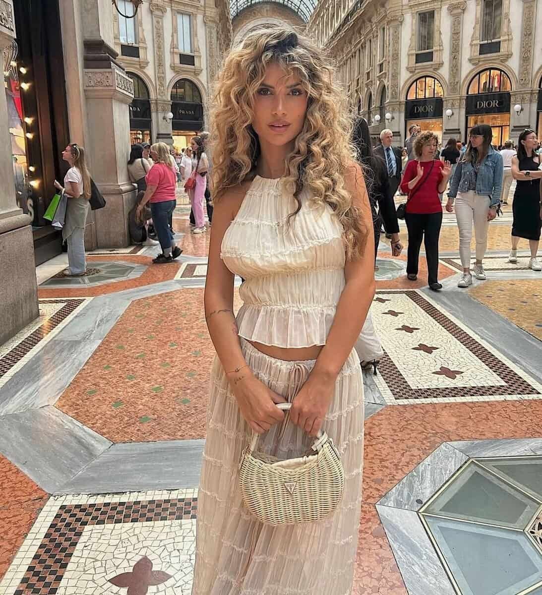 Boho Breeze summer outfit with ruffled details, halter top, and long skirt in a stylish urban setting.