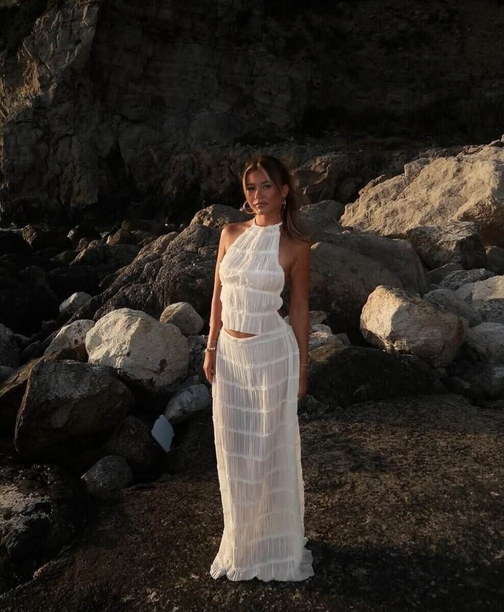 Boho Breeze: Elegant two-piece with ruffled details, featuring a halter top and partially sheer skirt, perfect for summer occasions.