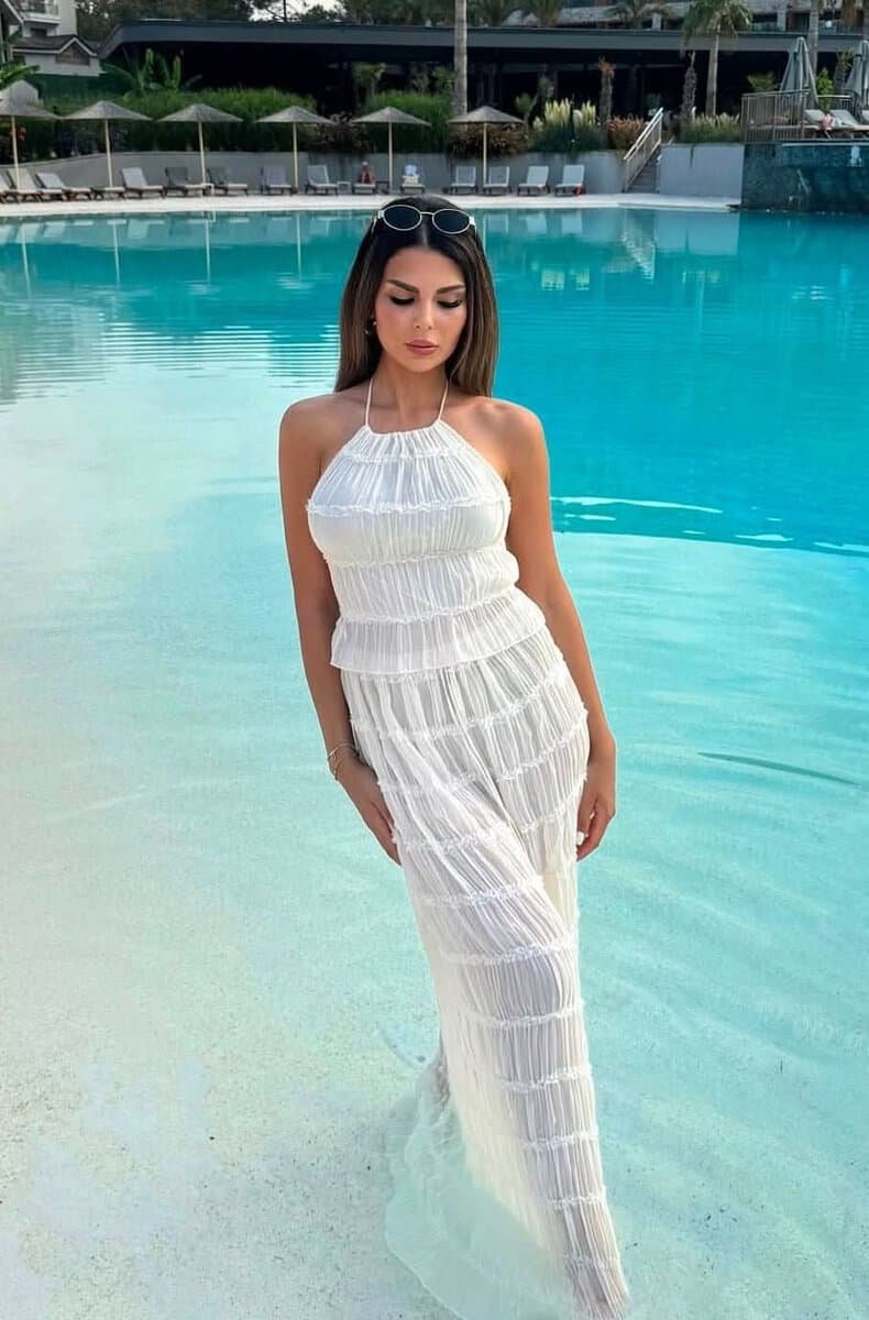 Boho Breeze summer two-piece outfit with ruffle details and halter top by the pool.