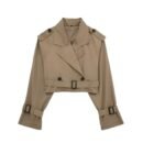 Cropped trench coat with broad lapel collar, shoulder epaulets, and belted waist, made from water-repellent cotton blend.