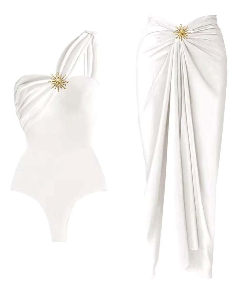 Elegance Beach Set with asymmetrical swimsuit and wrap skirt, featuring gold embellishment for a glamorous look.