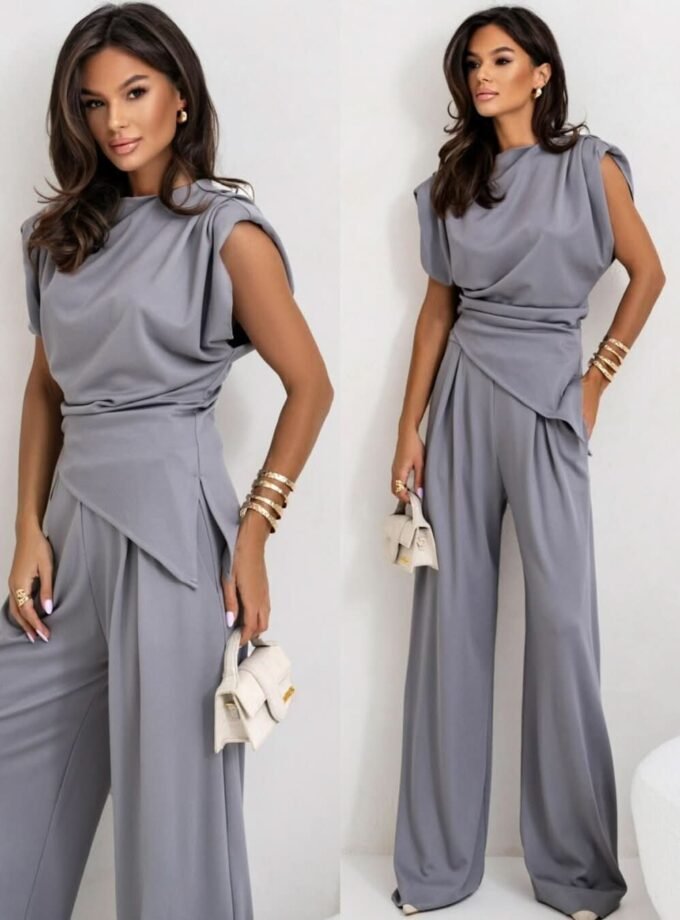 Elegant power suit set with sleeveless top, padded shoulders, and wide-leg pants for a modern, timeless look.