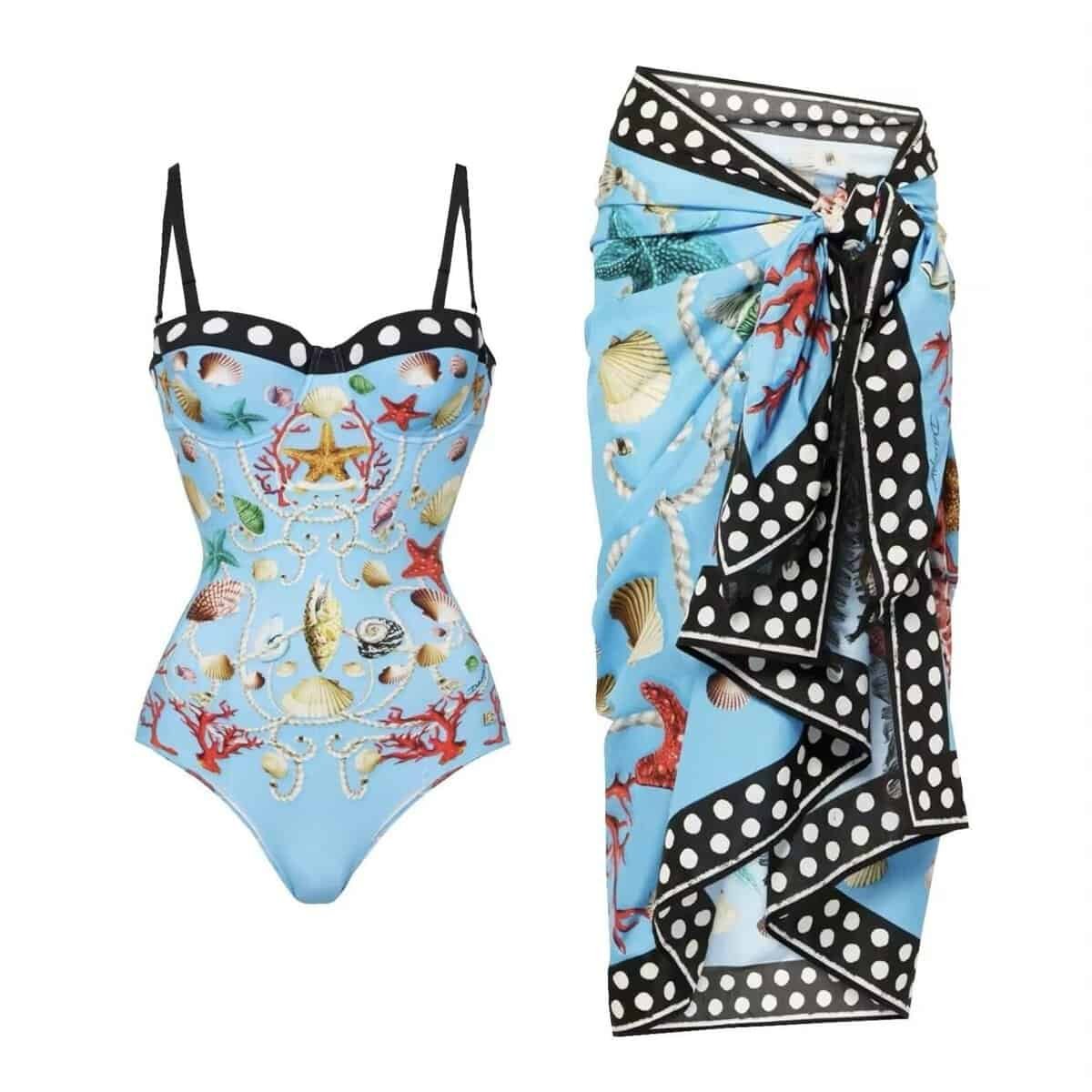 Luxurious 'Maritime Elegance' swim set featuring a shell and coral print swimsuit with a polka-dot trim sarong, in light blue.