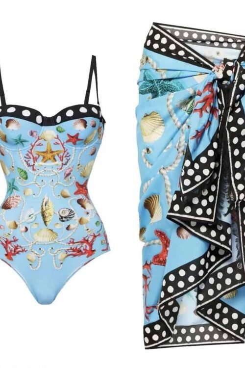 Luxurious 'Maritime Elegance' swim set featuring a shell and coral print swimsuit with a polka-dot trim sarong, in light blue.