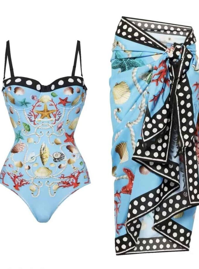 Luxurious 'Maritime Elegance' swim set featuring a shell and coral print swimsuit with a polka-dot trim sarong, in light blue.