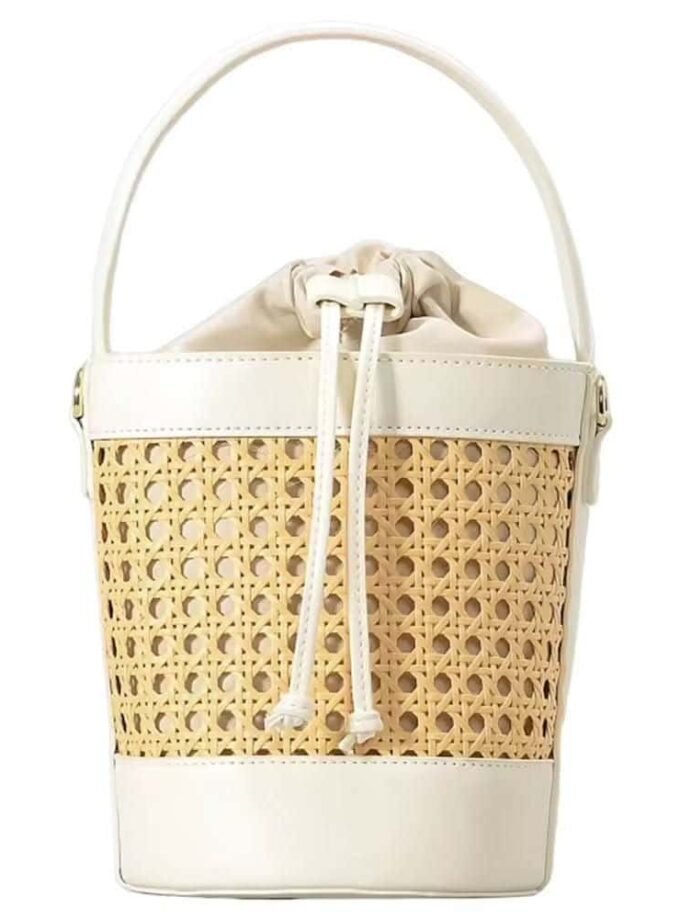 Cream and beige woven bucket bag with handle and drawstring closure.