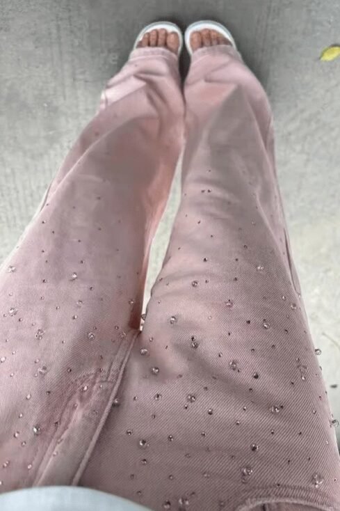 Rosé Pearl denim jeans with elegant pearl details, showcasing a relaxed fit and stylish embellishments.
