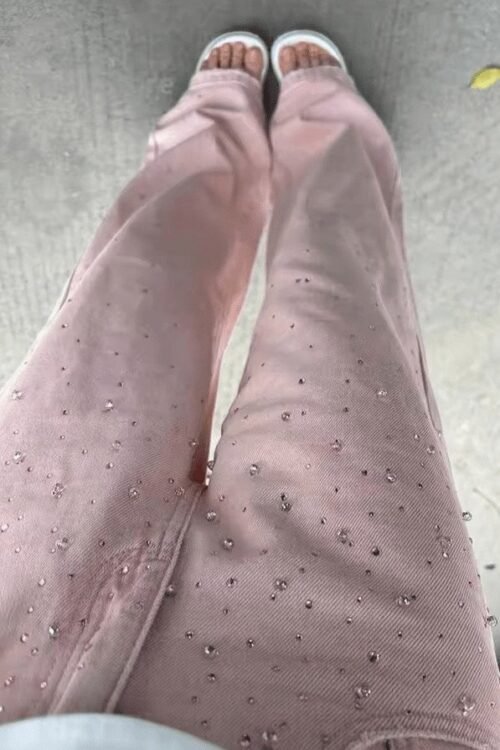 Rosé Pearl denim jeans with elegant pearl details, showcasing a relaxed fit and stylish embellishments.