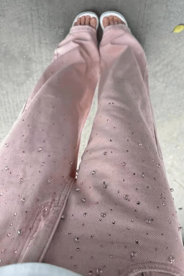 Rosé Pearl denim jeans with elegant pearl details, showcasing a relaxed fit and stylish embellishments.