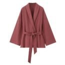 Soft wrap set with a flowing fabric wrap jacket, tie belt, and matching pants in a warm tone.