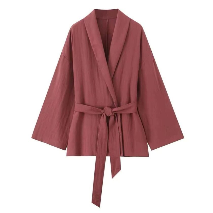Soft wrap set with a flowing fabric wrap jacket, tie belt, and matching pants in a warm tone.