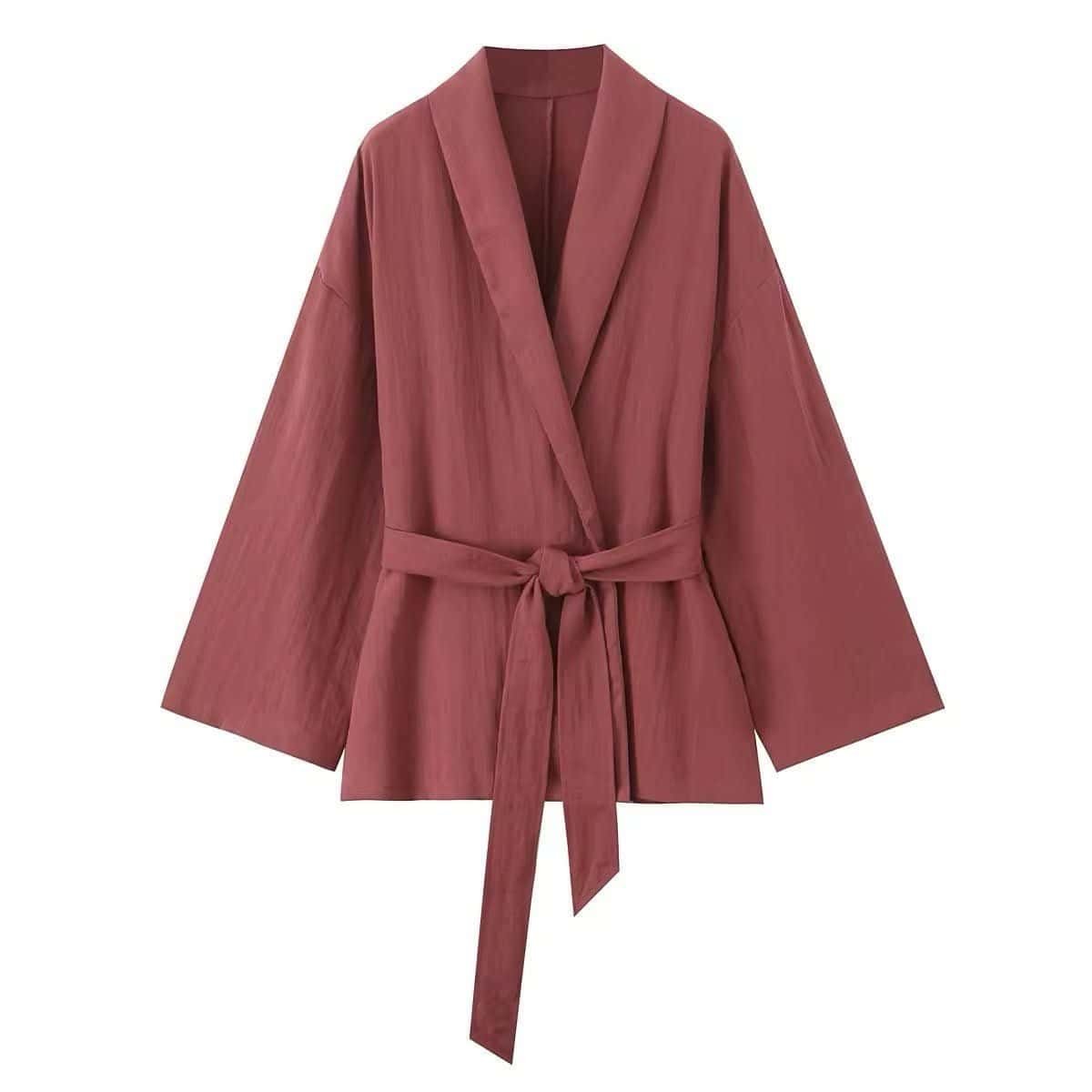 Soft wrap set with a flowing fabric wrap jacket, tie belt, and matching pants in a warm tone.